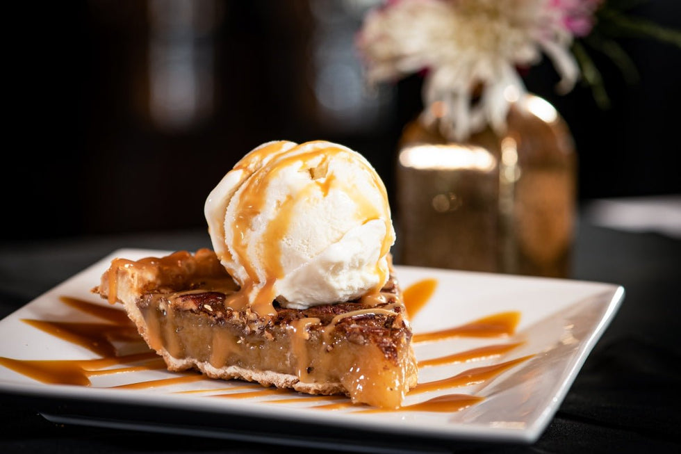 Pecan pie dump cake recipe served warm with a scoop of ice cream