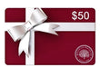 A $50 gift card for Millican Pecan Co. featuring a deep red background, a white horizontal stripe with a large white bow graphic, and the Millican Pecan Co logo